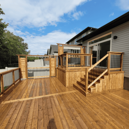 Pressure-treated deck with privacy panel and aluminum balusters in Almonte