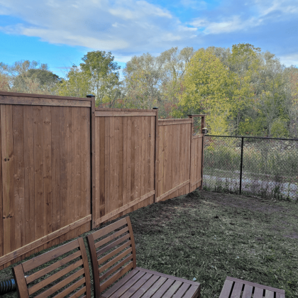 Pressure-treated wood fence in Carp