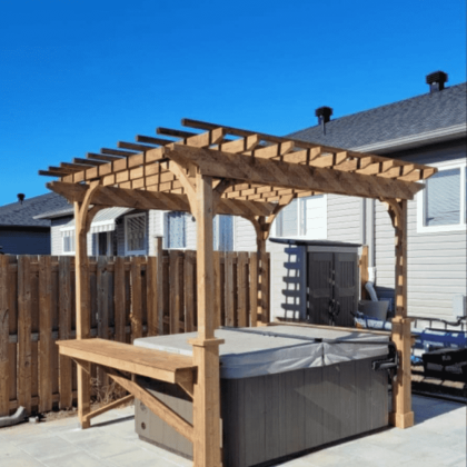 Pressure-treated deck with bar ledge and overhang surrounding a hot tub in Almonte