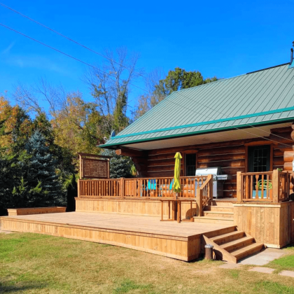 Low-level pressure-treated deck with privacy panel in Lanark County