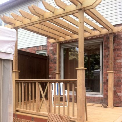 Pressure-treated pergola on deck at backdoor in Kanata