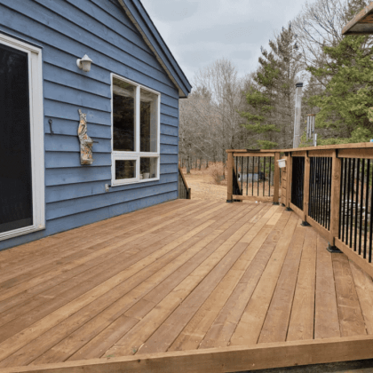 Resurfaced pressure-treated deck with black aluminum balusters in Almonte