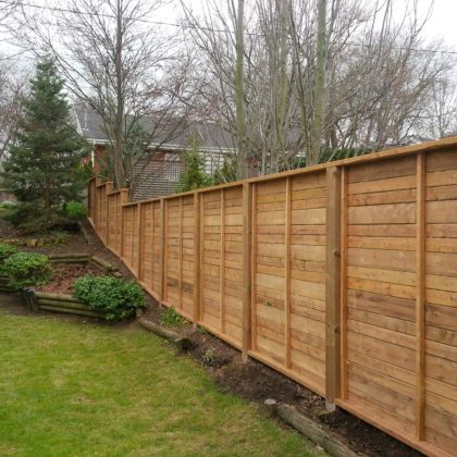 Horizontal pressure-treated panel fence in Stittsville